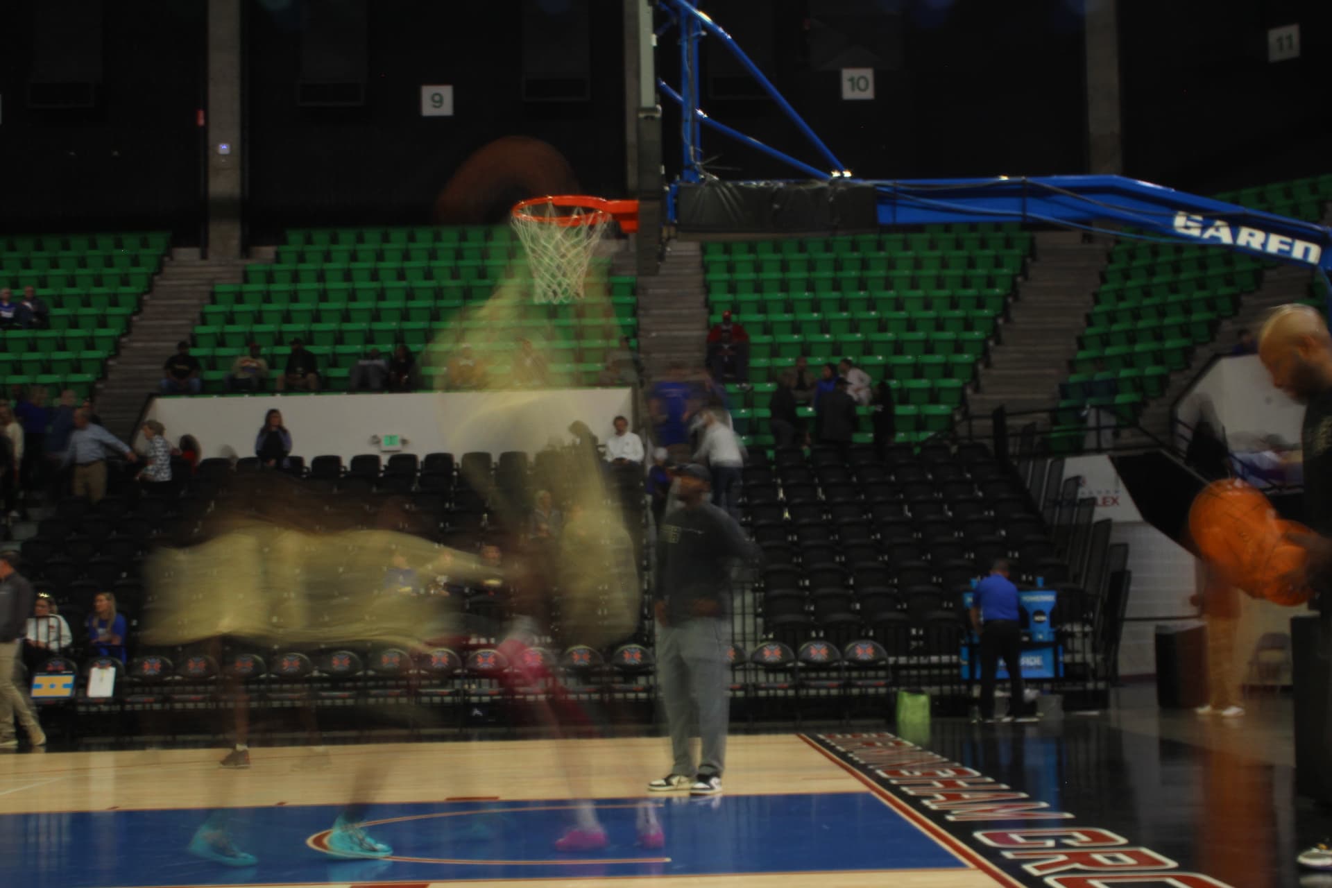 Long-exposure shot of a player driving to the basket during warmups
